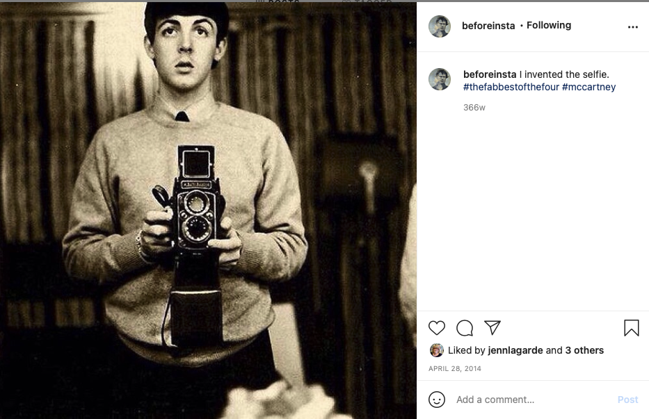 Paul McCartney taking a selfie with an old camera.