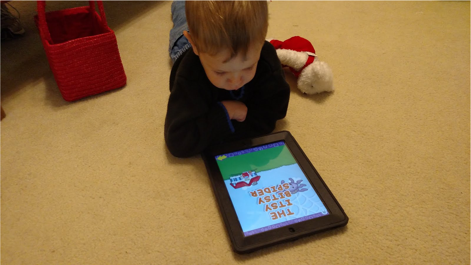 A child plays with a tablet.